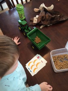 Preschool Boy playing tractor counting practice game