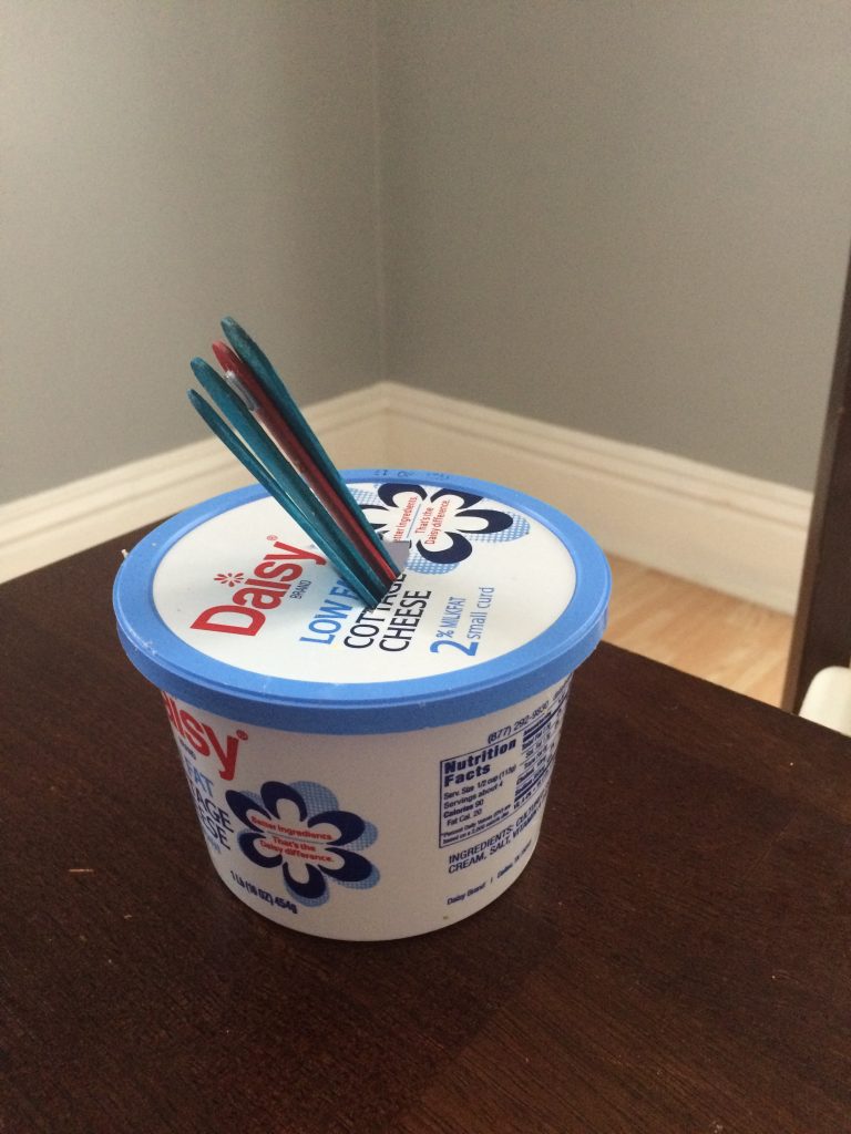 Sour Cream Container Used as A Toddler Activity